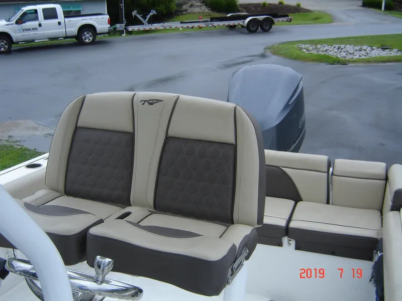 Slide: The Image of 2018 Tidewater 232 LXF boat with beige and brown seating. - 6