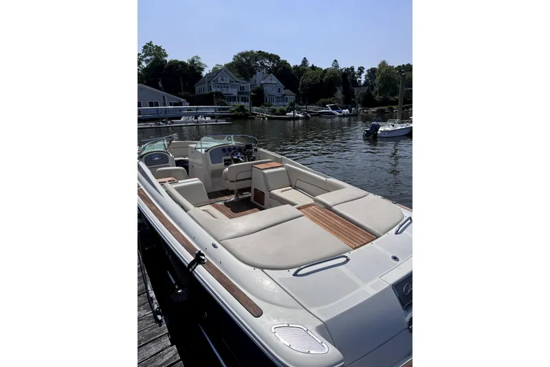 Slide: The Image of 2008 Chris-Craft Launch 28 boat docked by a scenic waterfront. - 3