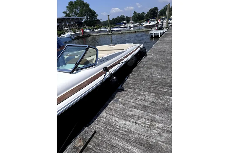 Slide: The Image of 2008 Chris-Craft Launch 28 docked at a marina, showcasing sleek design and classic style. - 5