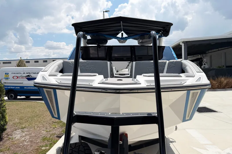 Slide: The Image of 2025 Nautique Super Air Nautique G25 Paragon boat, front view, outdoors. - 11