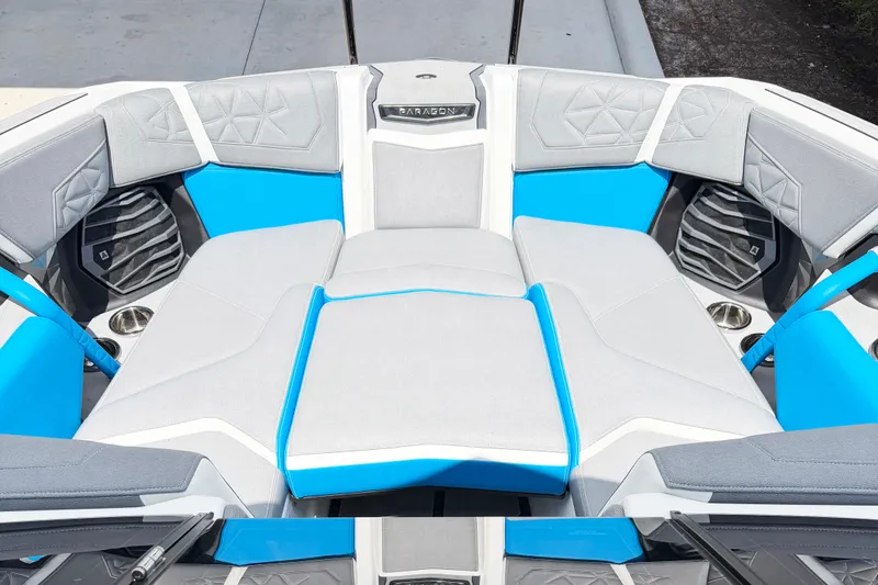 Slide: The Image of 2025 Nautique Super Air Nautique G25 Paragon boat interior with gray and blue seating. - 4