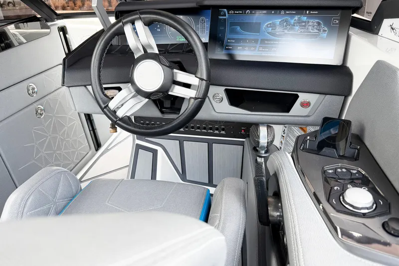 Slide: The Image of 2025 Nautique Super Air Nautique G25 Paragon cockpit with modern steering and digital display. - 6