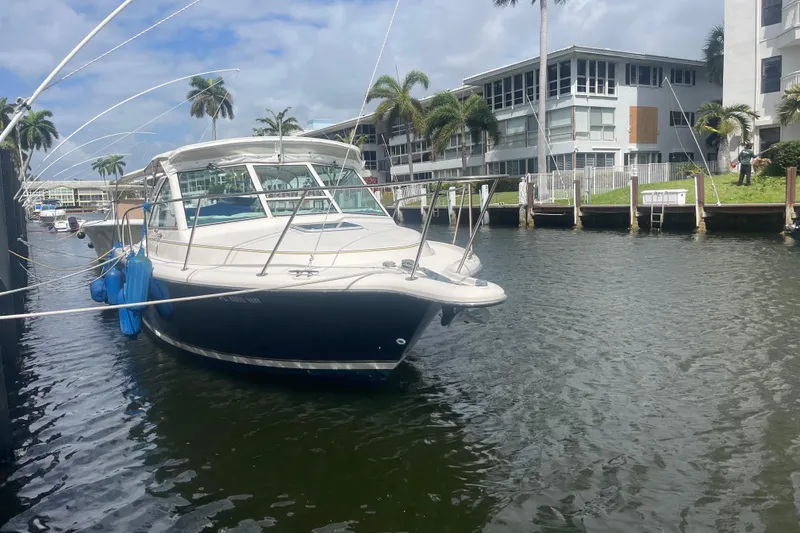 The Image of 2001 Tiara Yachts 2900 Coronet docked near waterfront buildings and palm trees. - 0