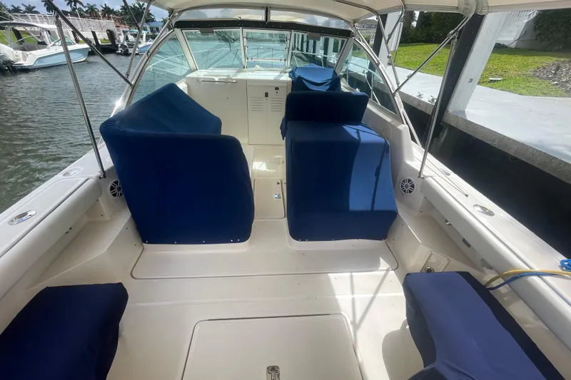 Slide: The Image of 2001 Tiara Yachts 2900 Coronet with blue seating, docked by the water. - 14