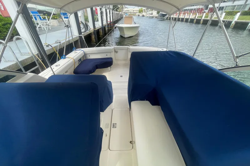 Slide: The Image of 2001 Tiara Yachts 2900 Coronet interior with blue seating, docked by the water. - 15