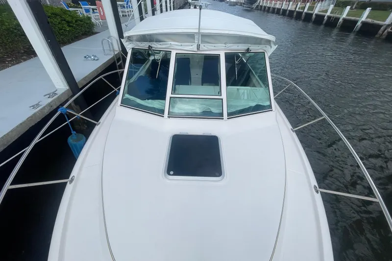 Slide: The Image of 2001 Tiara Yachts 2900 Coronet docked, showcasing sleek design and spacious deck. - 19