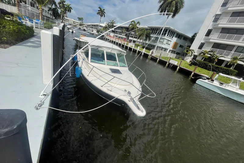 Slide: The Image of 2001 Tiara Yachts 2900 Coronet docked in a scenic canal with palm trees. - 3