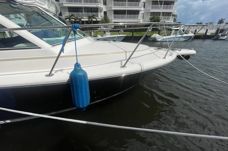 Slide: The Image of 2001 Tiara Yachts 2900 Coronet docked with blue fender, waterfront view. - 5