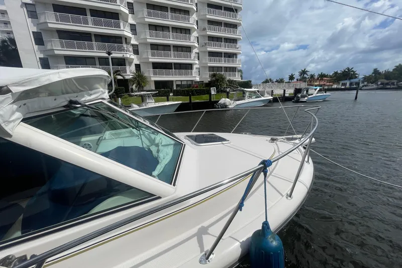 Slide: The Image of 2001 Tiara Yachts 2900 Coronet docked near waterfront apartments. - 8