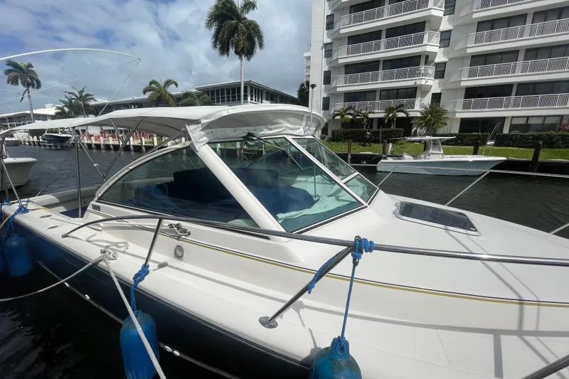 Slide: The Image of 2001 Tiara Yachts 2900 Coronet docked near waterfront buildings and palm trees. - 9