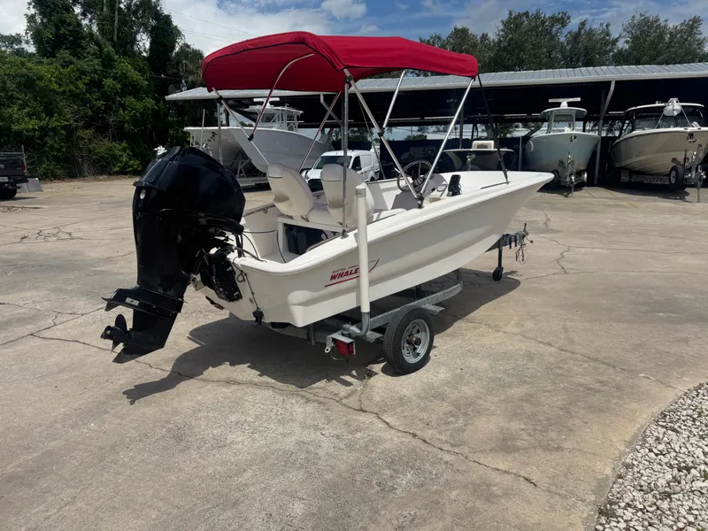 Slide: The Image of 2009 Boston Whaler 13 Sport with red canopy on trailer. - 2