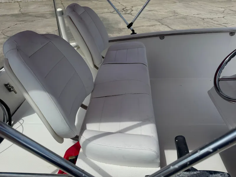 Slide: The Image of Interior of a 2009 Boston Whaler 13 Sport boat with white seats. - 5