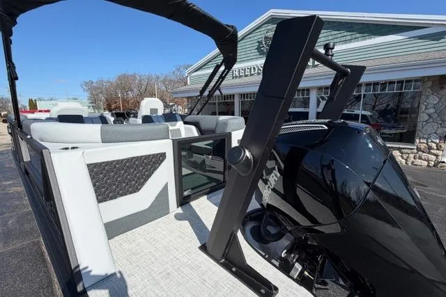 Slide: The Image of Alera M 23Q 2026 boat with sleek design and powerful engine, parked outdoors. - 12