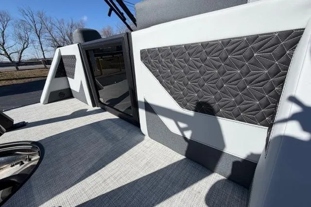 Slide: The Image of 2026 Alera M 23Q boat interior with geometric upholstery and sleek design elements. - 14