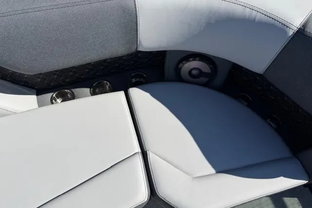 Slide: The Image of 2026 Alera M 23Q boat interior with gray cushioned seating and built-in cup holders. - 17