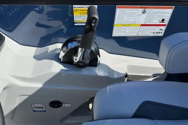 Slide: The Image of Control panel of 2026 Alera M 23Q boat with throttle lever and safety instructions. - 24