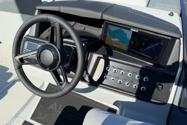 Slide: The Image of Steering wheel and dashboard of 2026 Alera M 23Q boat with navigation display. - 28