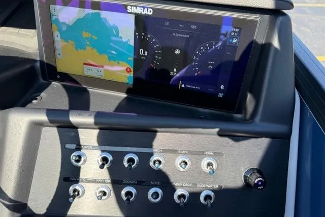 Slide: The Image of Control panel of Alera M 23Q 2026 with Simrad display and various switches. - 29