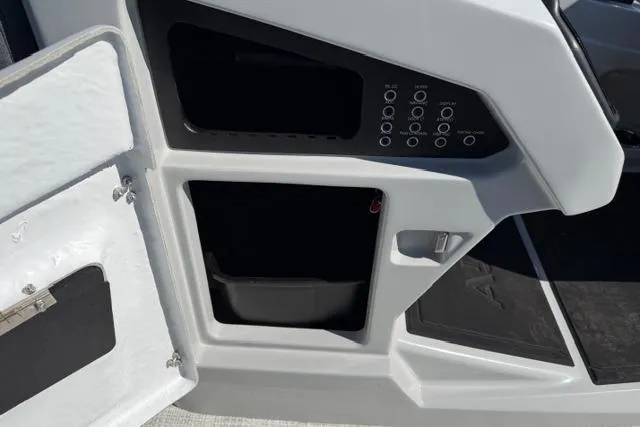 Slide: The Image of Control panel and storage compartments on 2026 Alera M 23Q boat. - 32