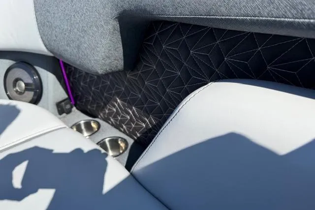 Slide: The Image of Luxurious interior of 2026 Alera M 23Q with geometric patterns and cup holders. - 36