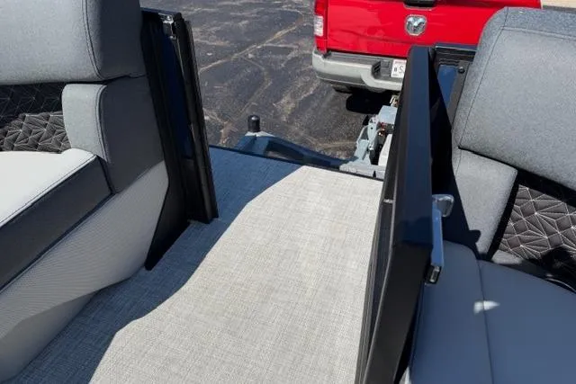 Slide: The Image of Interior view of 2026 Alera M 23Q boat with gray seating and red truck in background. - 40