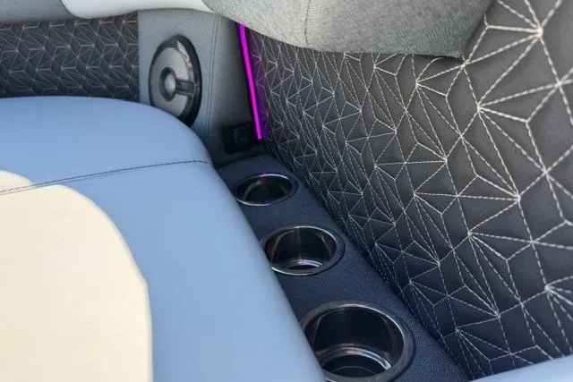 Slide: The Image of Luxury interior of 2026 Alera M 23Q with geometric stitching and cup holders. - 51