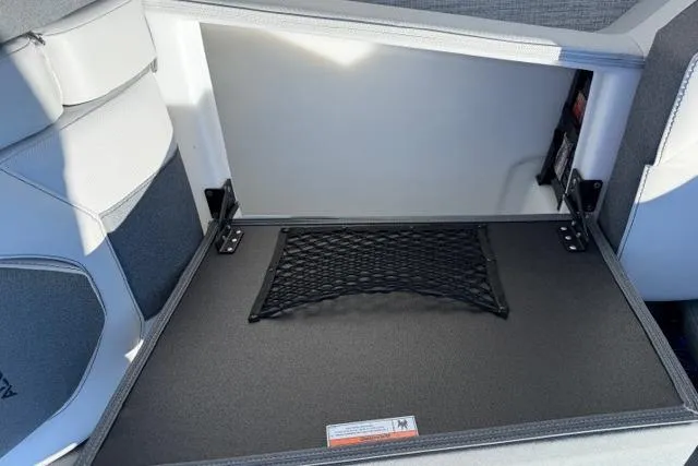 Slide: The Image of Interior storage compartment of 2026 Alera M 23Q with netting and sleek design. - 52