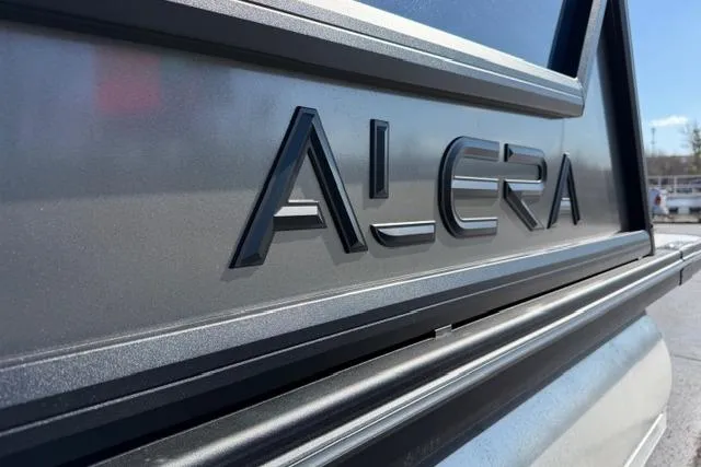 Slide: The Image of Close-up of 2026 Alera M 23Q logo on vehicle exterior. - 6