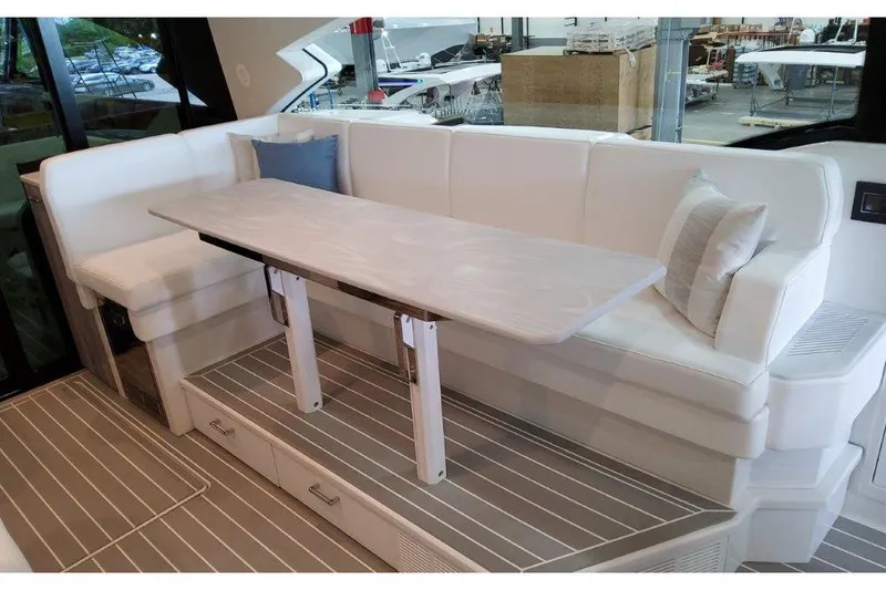 Slide: The Image of 2023 Formula 500 Super Sport Crossover interior with white seating and adjustable table. - 56