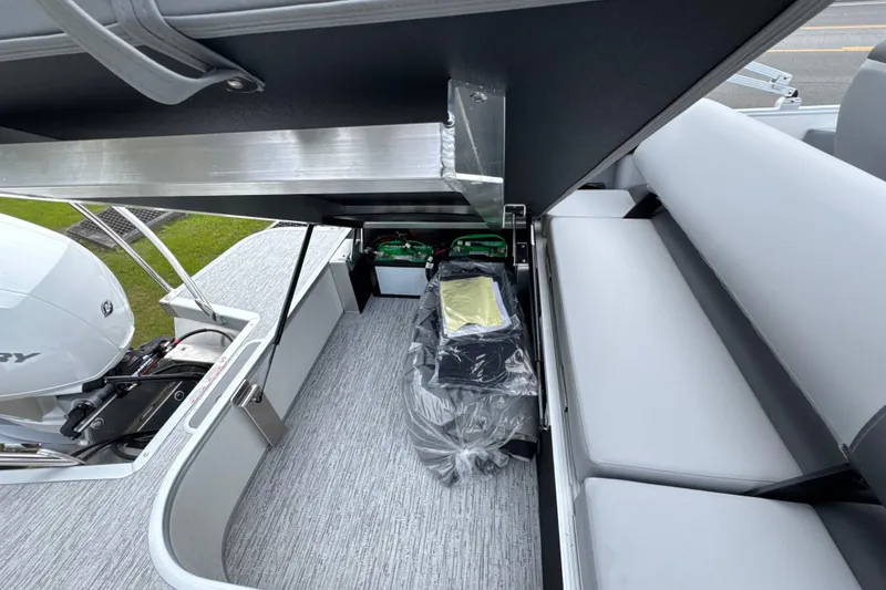 Slide: The Image of Interior view of 2026 Bennington 22 SSB boat, showcasing seating and storage compartments. - 14