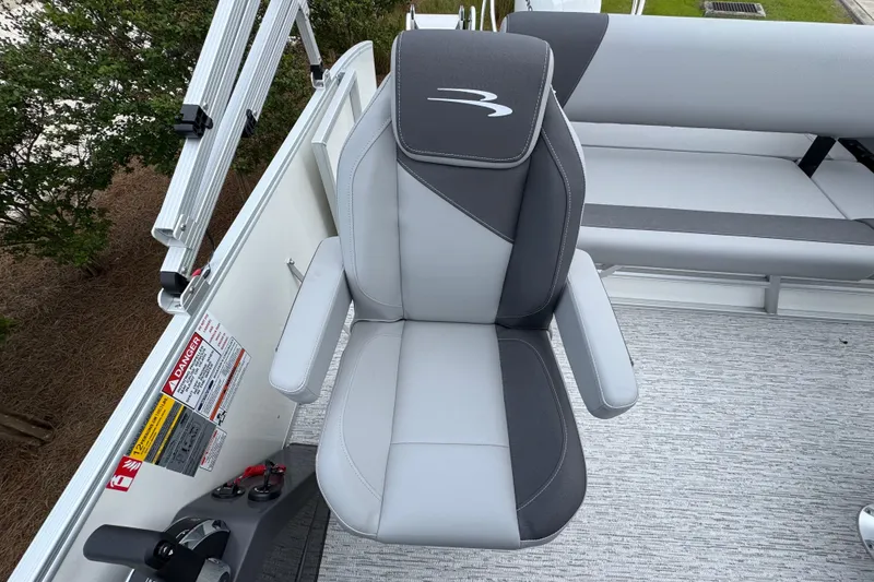 Slide: The Image of Captain's chair on 2026 Bennington 22 SSB pontoon boat, featuring sleek gray upholstery. - 21