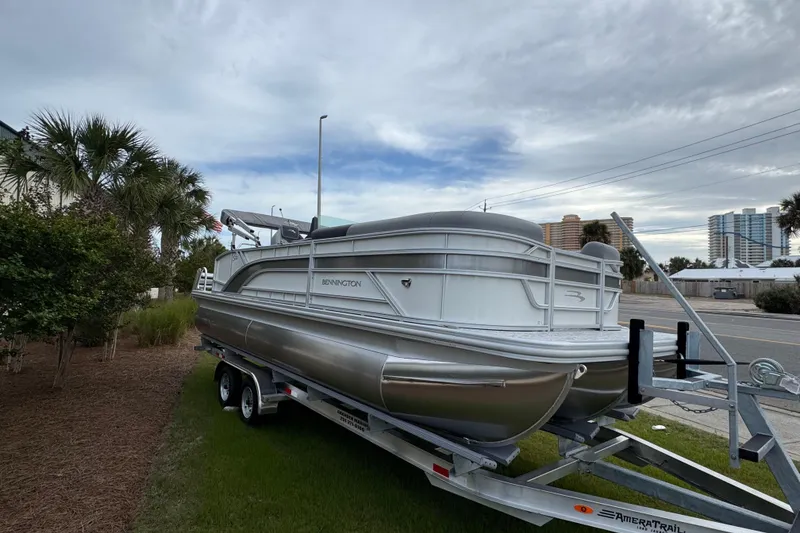 Slide: The Image of 2026 Bennington 22 SSB pontoon boat on trailer, parked outdoors. - 4