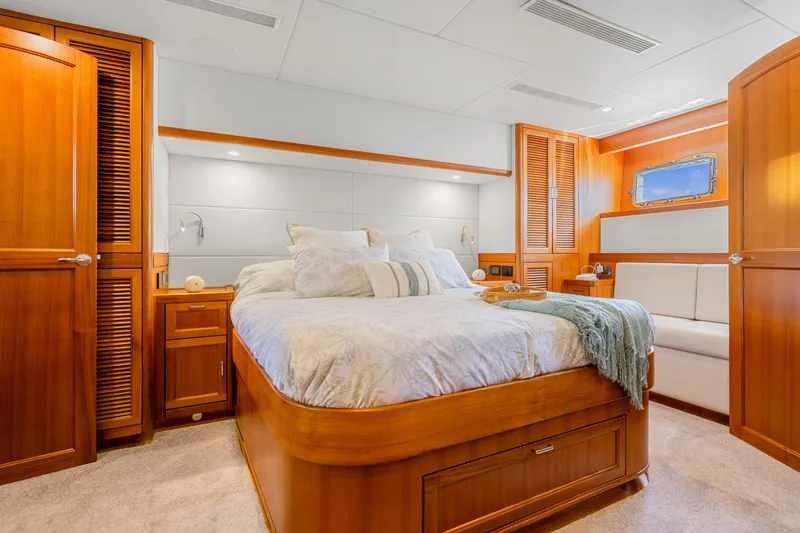 Slide: The Image of Luxurious cabin interior of 2023 Fleming 85 yacht with elegant wood finishes and cozy bedding. - 12