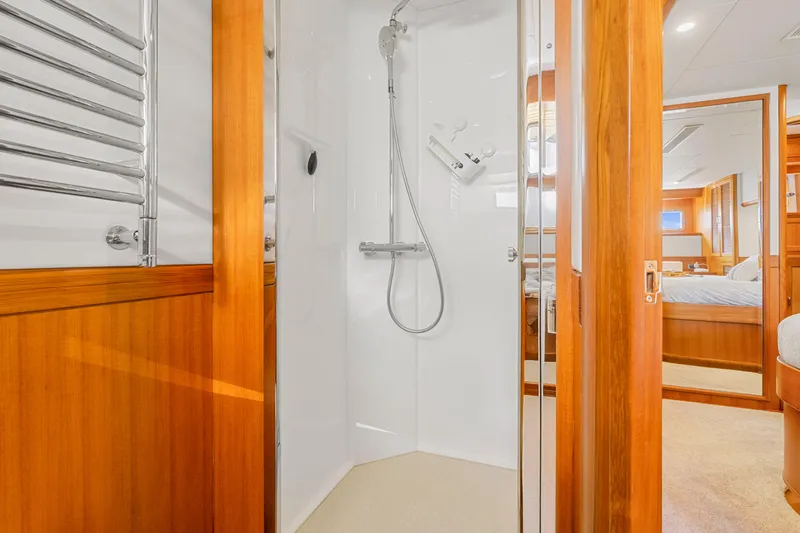 Slide: The Image of Luxurious bathroom on 2023 Fleming 85 yacht with wooden accents and modern shower. - 14