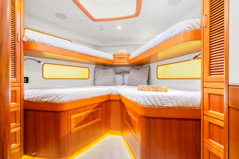 Slide: The Image of Luxurious 2023 Fleming 85 yacht cabin with wooden bunk beds and modern lighting. - 17