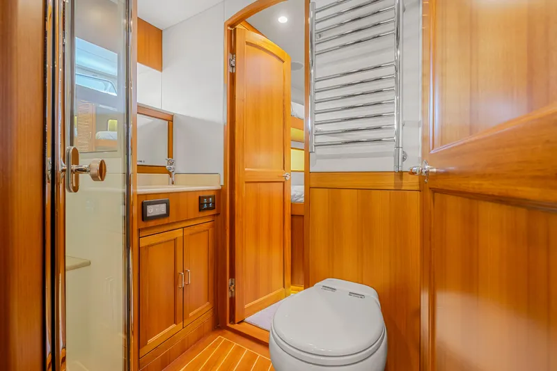 Slide: The Image of Luxurious 2023 Fleming 85 yacht bathroom with wooden cabinetry and modern fixtures. - 18