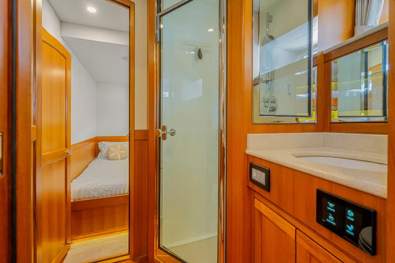 Slide: The Image of Luxurious Fleming 85 yacht interior with bedroom, shower, and vanity, 2023 model. - 19