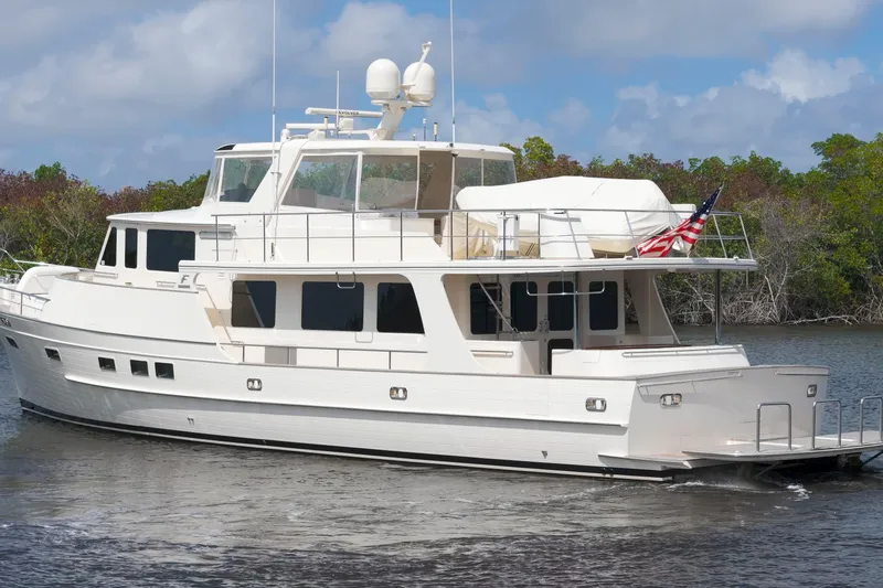 Slide: The Image of Luxury Fleming 85 yacht cruising on a serene waterway, 2023 model. - 2