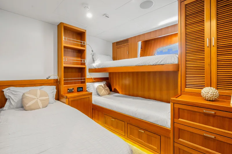 Slide: The Image of Luxurious Fleming 85 yacht cabin with wooden bunk beds and modern amenities, 2023 model. - 20