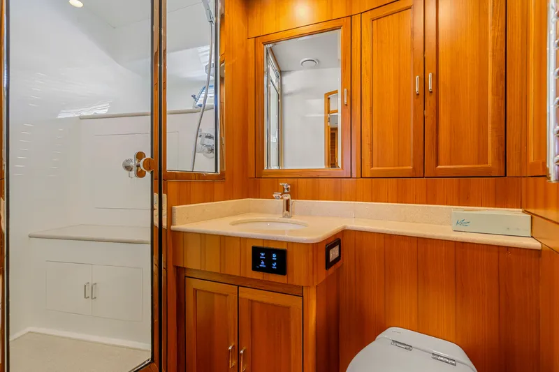 Slide: The Image of Luxurious wooden bathroom interior in 2023 Fleming 85 yacht, featuring modern fixtures and shower. - 22