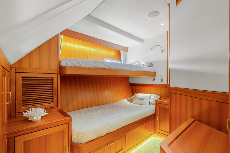 Slide: The Image of Luxurious wooden cabin with bunk beds in a 2023 Fleming 85 yacht. - 23