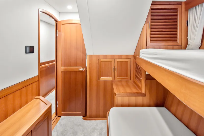 Slide: The Image of Luxurious wooden interior of 2023 Fleming 85 yacht cabin with bunk beds. - 24