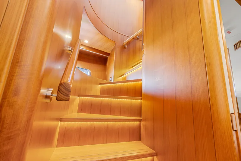 Slide: The Image of Wooden staircase with ambient lighting inside a 2023 Fleming 85 yacht. - 26