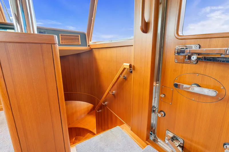Slide: The Image of Interior of 2023 Fleming 85 yacht with wooden staircase and door details. - 27