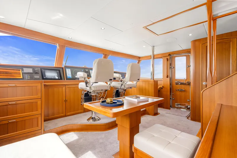 Slide: The Image of Luxurious 2023 Fleming 85 yacht interior with wooden finishes and modern navigation equipment. - 28