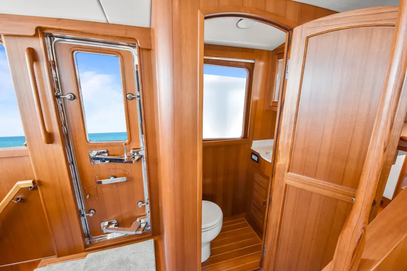 Slide: The Image of Luxurious wooden interior of 2023 Fleming 85 yacht bathroom with ocean view. - 29