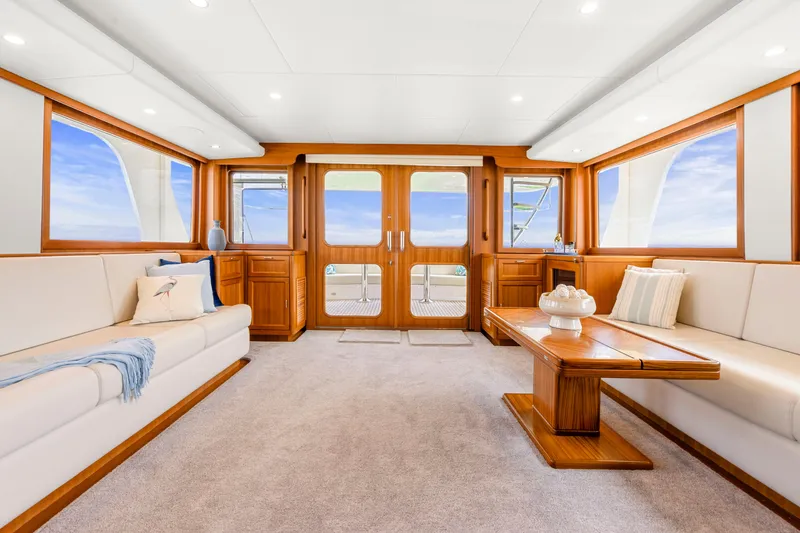 Slide: The Image of Luxurious interior of 2023 Fleming 85 yacht with elegant wood finishes and plush seating. - 3