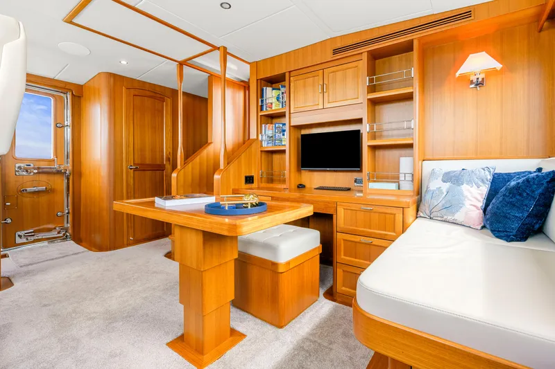 Slide: The Image of Luxurious interior of 2023 Fleming 85 yacht with wooden furnishings and cozy seating area. - 30