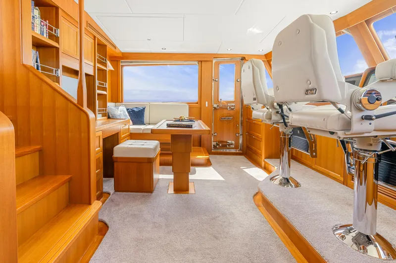 Slide: The Image of Luxurious interior of 2023 Fleming 85 yacht with elegant wood finishes and plush seating. - 31