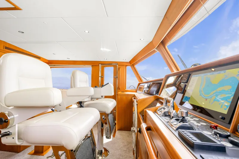 Slide: The Image of Luxurious 2023 Fleming 85 yacht helm with modern navigation equipment and plush seating. - 32